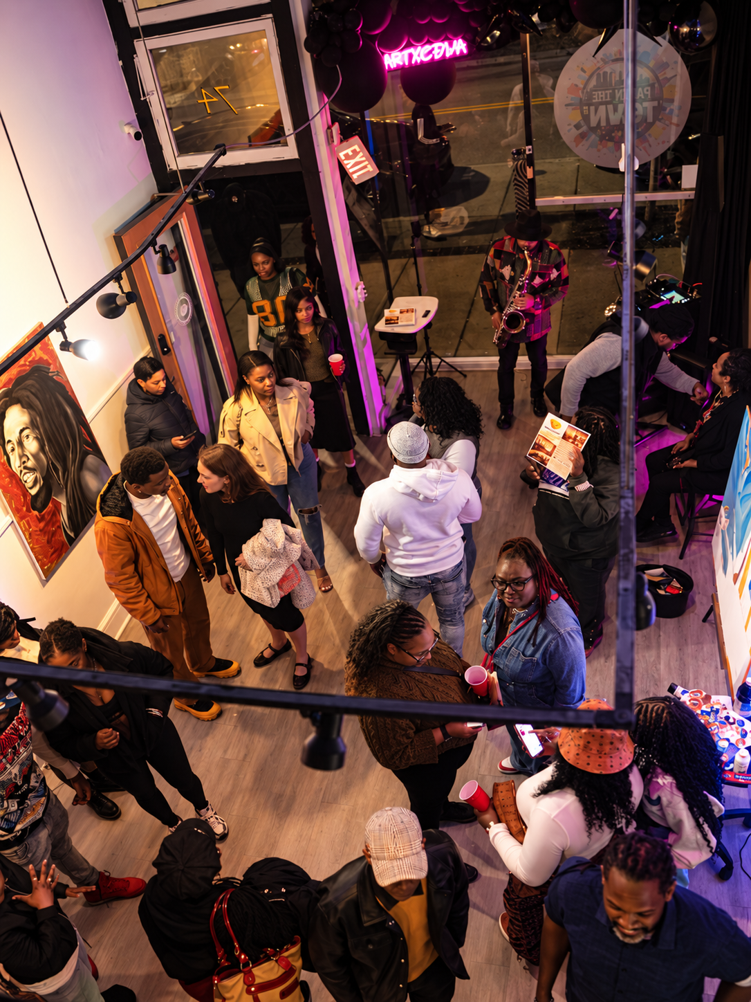 Guests gathering among artwork at Paint the Town